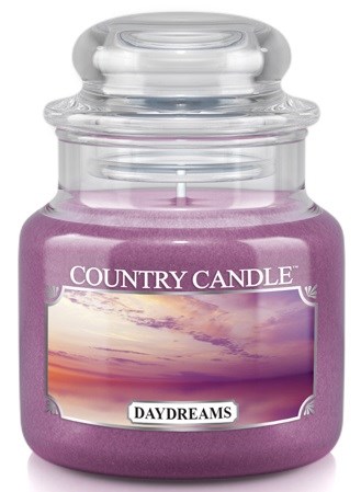 En lila ljuslykta med glaskork, märkt 'Country Candle' och 'Daydreams', visar en solnedgång på etiketten.