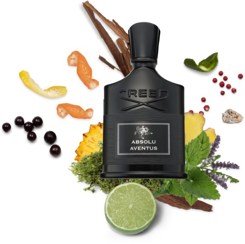 En svart flaska med Creed Absolu Aventus-parfym omgiven av örter, frukter och kryddor.