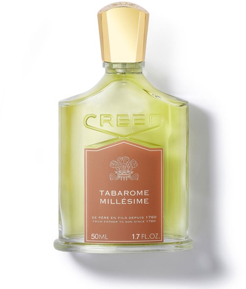 En parfymflaska med gulgrön vätska, guldkork och rosa etikett med texten 'Tabarome Millesime' och 'Creed' högst upp.
