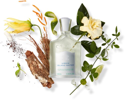 En flaska Virgin Island Water-parfym omgiven av tropiska blommor, blad och en lime.