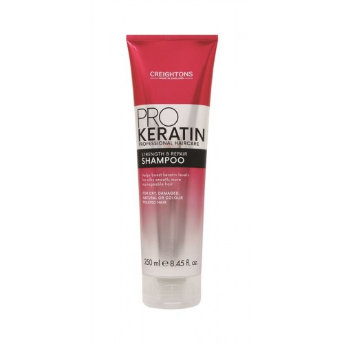 En tube med rødt og hvitt sjampo merket Pro Keratin for styrke og reparasjon, egnet for tørt, skadet eller farget hår.