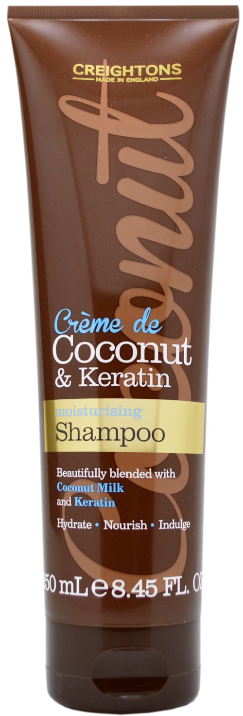 En brun tub med Creightons kokos- och keratin närande schampo med gul och vit etikett.