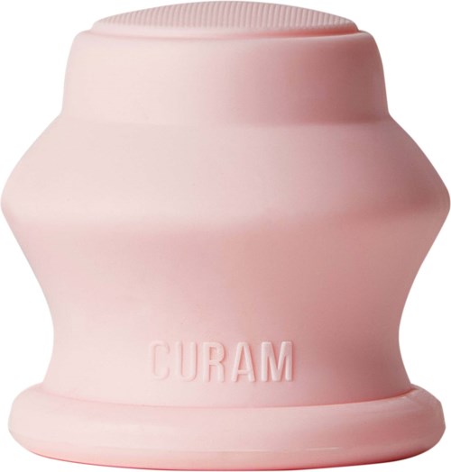 A pink cylindrical object with the word 'CURAM' embossed on it, having a rounded top and a wider base.