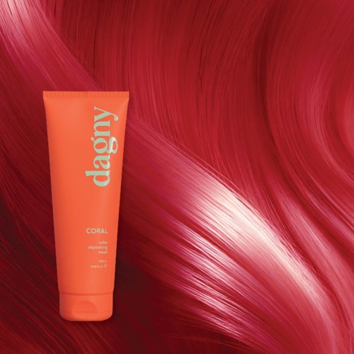 A coral-colored hair masking product tube on a red flowing hair background.