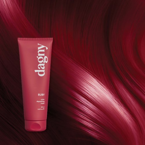 A pink tube of hair mask with a background of flowing red hair.