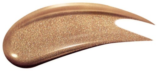 Et prøvetryk af glitrende, gyldne makeup eller kosmetik, spredt ud i en buet form.