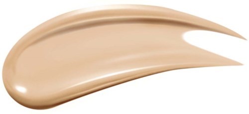 En beigefärgad kosmetisk produkt är utbredd i en kurvad, penseldagsform. Den ser slät och glansig ut.