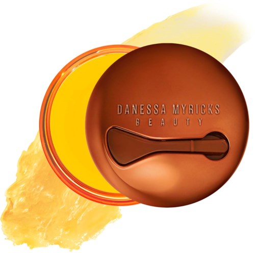 En rund bronze compact med mærket 'Danessa Myricks Beauty' og et spejl indvendigt.