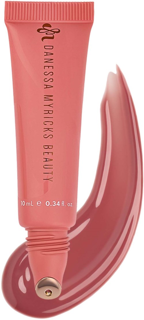 A pink tube of skincare or makeup product with a shiny smear of product rolled out beside it.
