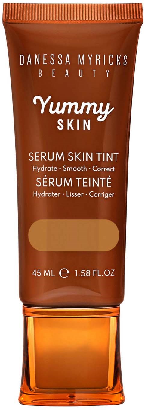 A brown tube of Danessa Myricks Yummy Skin Skin Tint with a clear orange cap, 45 ml size.