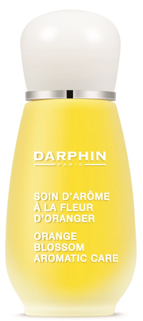 A small yellow bottle with a white cap, labeled Darphin orange blossom aromatic care, flower scent.