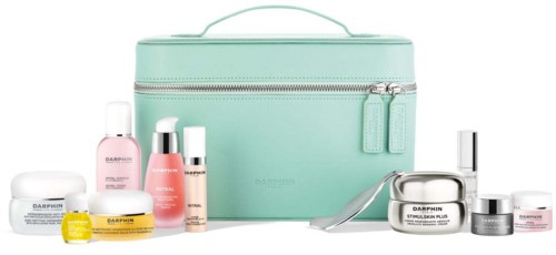 A light green cosmetic bag with makeup and skincare products in front. The products are in different bottles and jars.