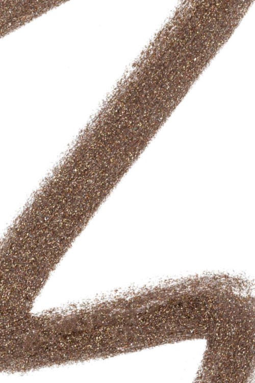 A brown, glittery line curves on a white background.