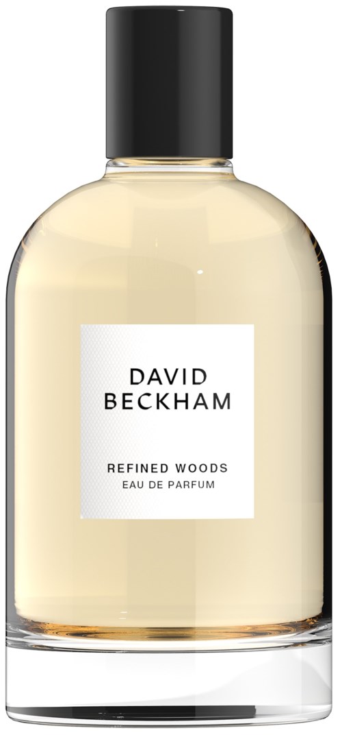Eine klare Glasparfümflasche mit schwarzem Deckel, beschriftet David Beckham Refined Woods Eau de Parfum.