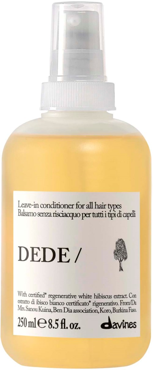 Leave-in conditionerflaska med vit etikett och liten trädlogga, innehållande 250 ml gul vätska.