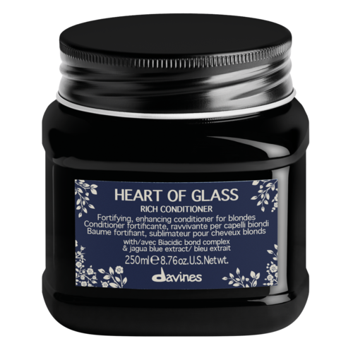 A black jar of hair conditioner labeled "Heart of Glass," with blue and white design, holding 250ml.