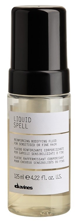 En liten klar flaska med svart lock, märkt 'Liquid Spell' för hårvård, innehåller 125 ml produkt.