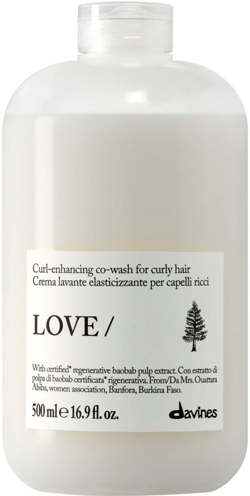 Hvit flaske med curl-enhancing co-wash for krøllete hår med enkel etikett og liten tre-ikon.