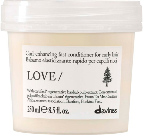 Förpackning av Davines Love-rund-accelererande balsam med vit lock och etikett som beskriver ingredienser och storlek.