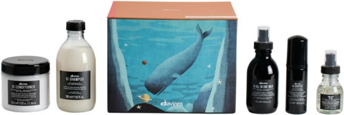 A set of hair care products including shampoo, conditioner, hair oil, serum, and a box with a whale illustration.