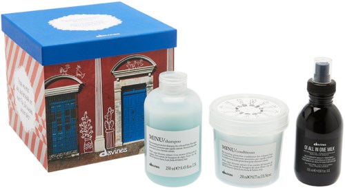 A set of hair care products from Davines, including shampoo, conditioner, and hair oil, with a festive, holiday-themed box.