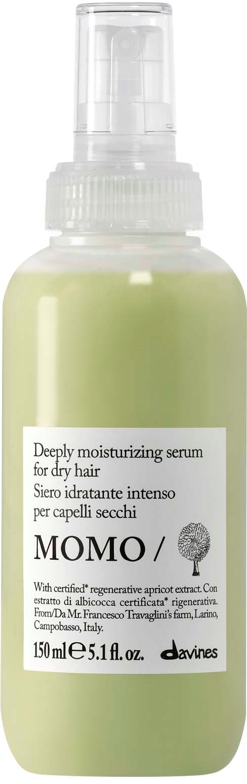En ljusgrön flaska med fuktgivande serum för torrt hår, utrustad med spraypump och vit etikett.