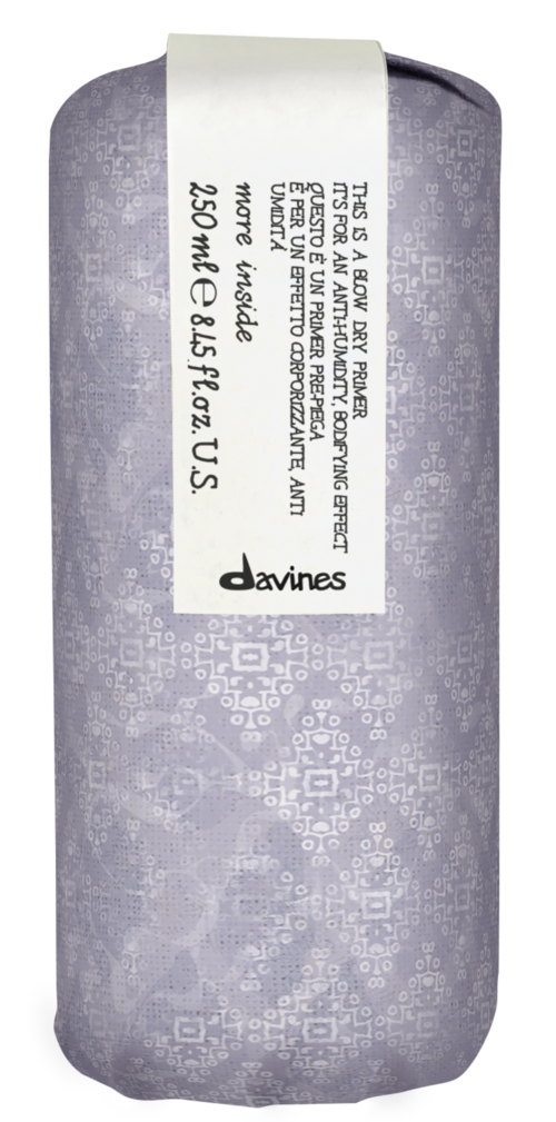 A cylindrical package with a label showing text, logo, and silver design, likely a product packaging.