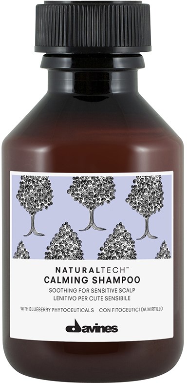A brown bottle with a black cap, labeled 'Calming Shampoo' for sensitive scalp with blueberry extract, from Davines.