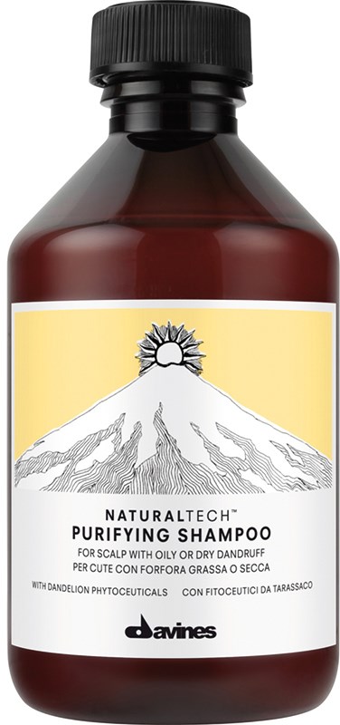 Mørkebrun flaske med etiket, viser et bjerg og sol, indeholder rensende shampoo til hovedbund med skæl.