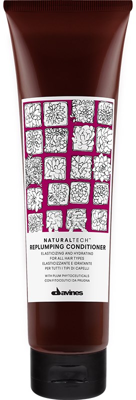 En brun tube mærket 'Replumping Conditioner' med blomsteropsætning og pink detaljer. Den er til hårpleje og hydrering.
