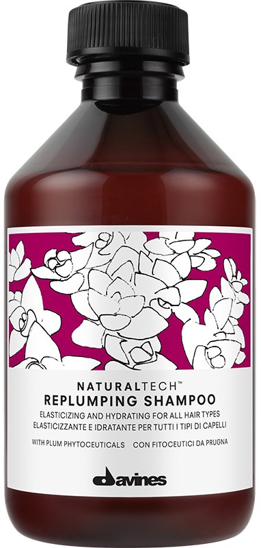 En brun flaske af Davines Replumping Shampoo med en pink og hvid etiket med blomster og blade.