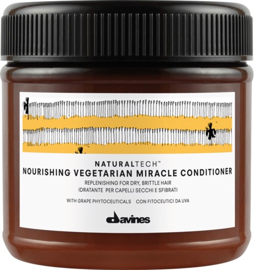 Et glas med nærende vegetarisk balsam til tørt, brustent hår med sort låg og mærkat med gule striber.