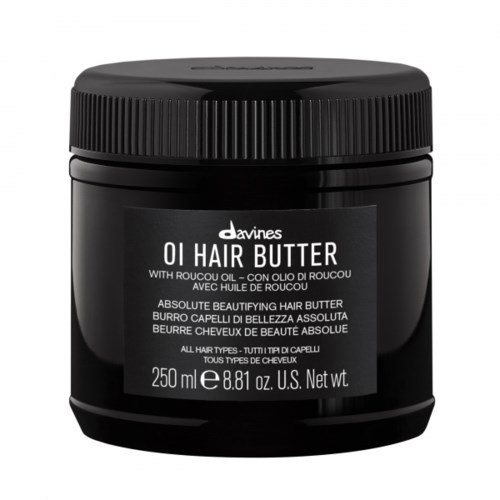 En sort krukke med Davines OI Hair Butter med skruelåg, hvid etikette, indeholder hårplejeprodukt.