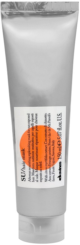 En silverrör med en vit etikett, orange cirkel och text. Det verkar vara en personlig vård- eller kosmetikprodukt.