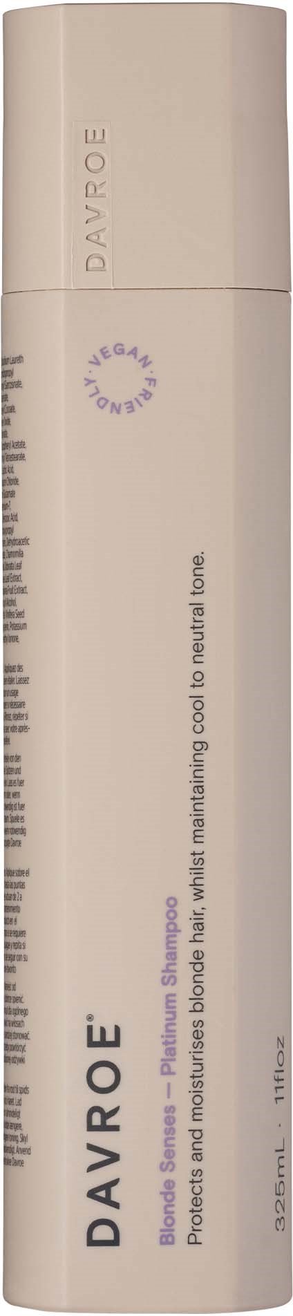 En beige cylindrisk flaska med vitt lock och svart textetikett, troligen en hudvårds- eller kosmetikprodukt.