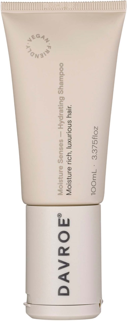 A white tube of Davroe shampoo with light gray text, describing it as hydrating for luxurious hair, 100ml size.