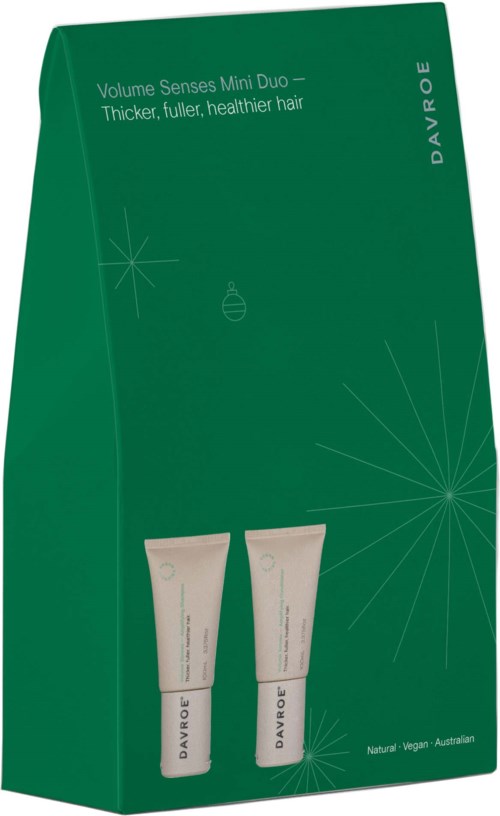 Grønt eske med to små tuber, tekst om hårvolum og helse, merke Davroe, enkel stjerneformet design.