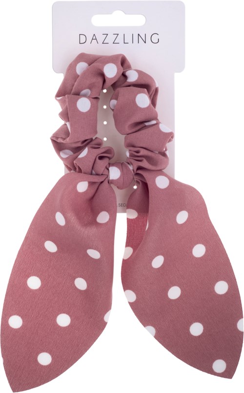 A pink polka dot scrunchie with a bow, on a white card labeled "Dazzling."