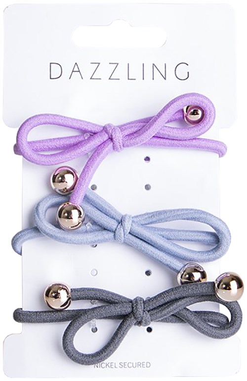 Tre pastellfärgade hårband med små guldbollar, fästa på en kortetikett märkt "DAZZLING."