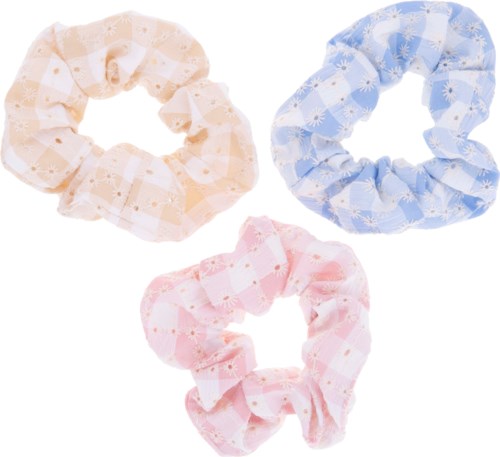 Three pastel-colored fabric scrunchies: peach, blue, and pink, with floral and checkered patterns.