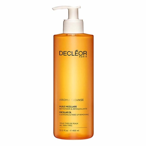 En lang oransje flaske med hvit pumpe, merket Decleor Aroma Cleanse Micellar Oil for alle hudtyper.