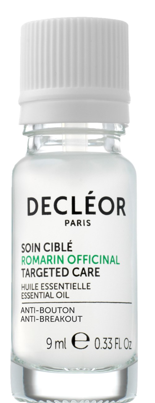 En liten klar flaska med vit lock, märkt Decléor Paris, innehåller essentiell olja för specifik hudvård, 9 ml.
