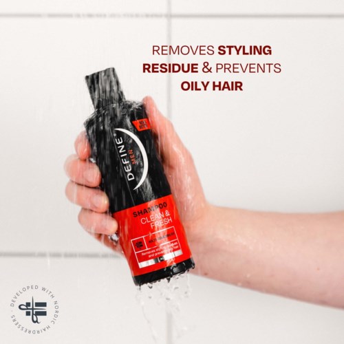 A person holds a black and red shampoo bottle under running water, with text about removing oil and residue.