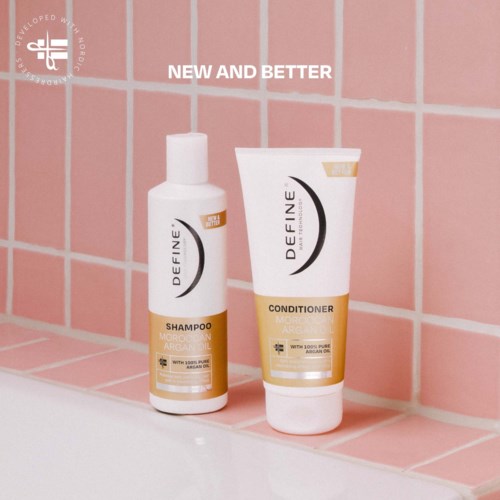 Two hair product bottles on pink tiled wall, labeled Define Shampoo and Conditioner with Argan oil.