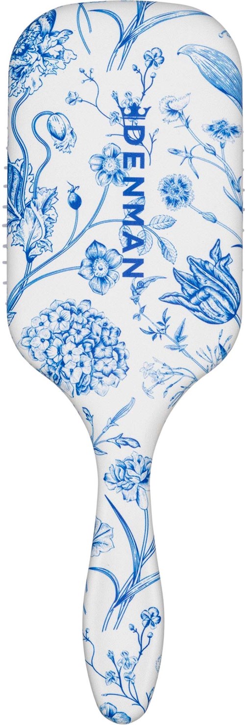 A white paddle with blue floral designs and the word DEVMAN in blue. The paddle is long and curved.