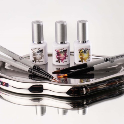 Three bottles of nail gel polish and tools are arranged on a shiny, reflective surface.