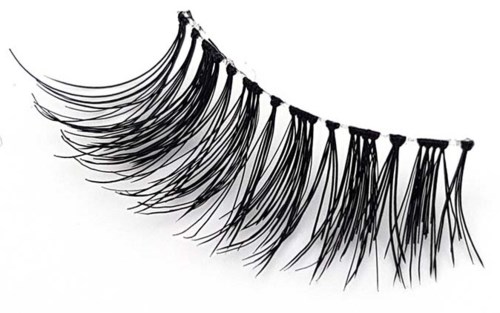 A set of false eyelashes with long, curled, and dark synthetic fibers spread out on a white background.