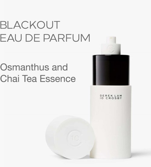 A white and black perfume bottle with a round white cap, labeled with scent and ingredients, on a white background.