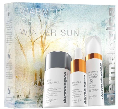 Set med hudvård för vintervärme, inklusive mikropeeling, serum och fuktkräm i eleganta flaskor.