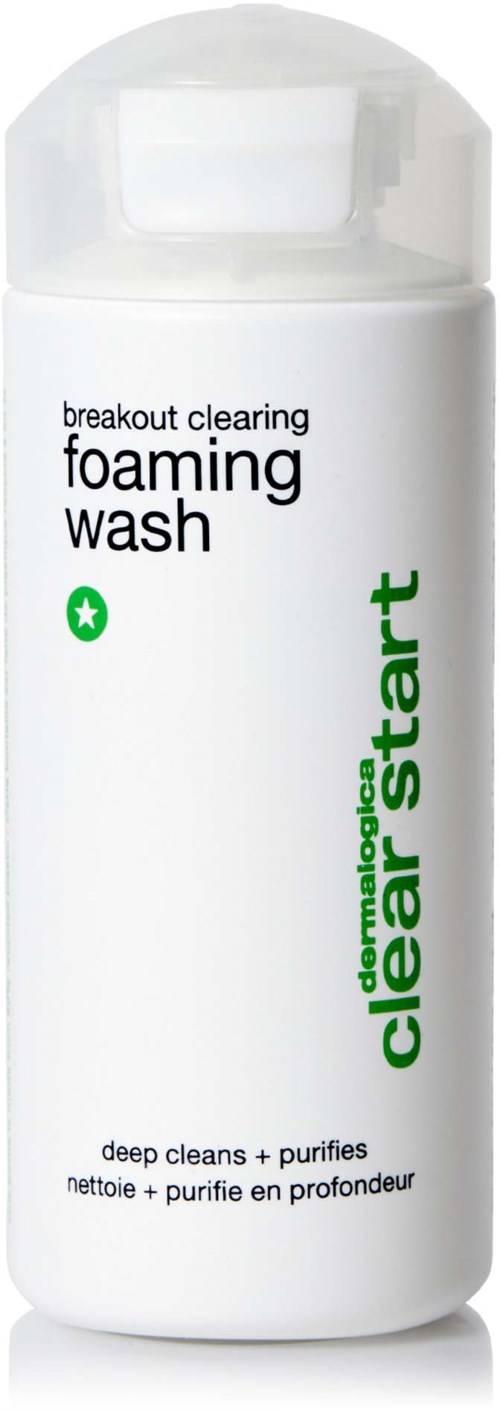 A white bottle of breakouts clearing foaming wash with green and black text, and a clear cap.
